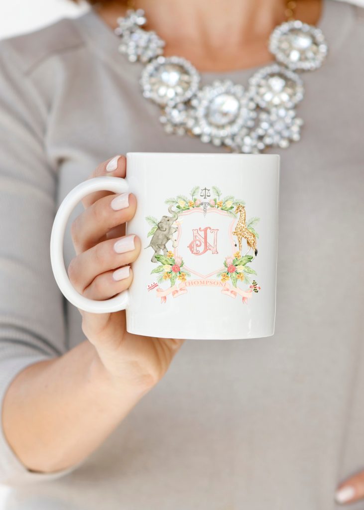 A watercolor crest coffee mug by Alicia Betz of The Welcoming District.