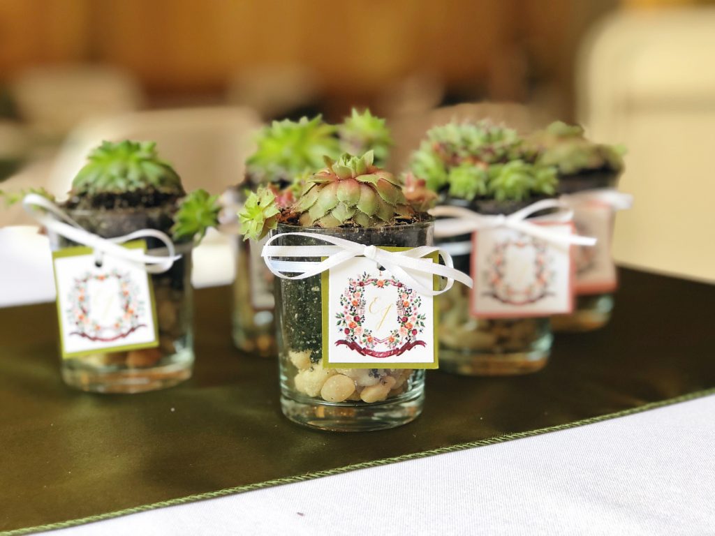 The couple's watercolor wedding crest was applied to gift tags on their succulent wedding favors adding lots of personality to the wedding reception! The crest was painted by Alicia Betz of The Welcoming District.