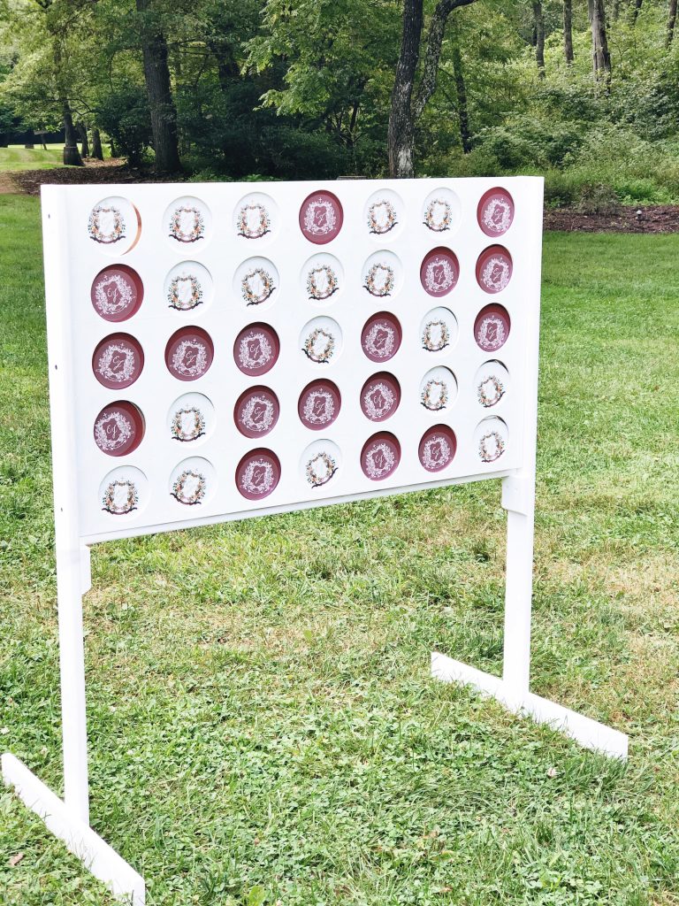 The couple's watercolor wedding crest was applied to Connect 4 discs offering a fun game and lots of personality to the wedding reception! The crest was painted by Alicia Betz of The Welcoming District.