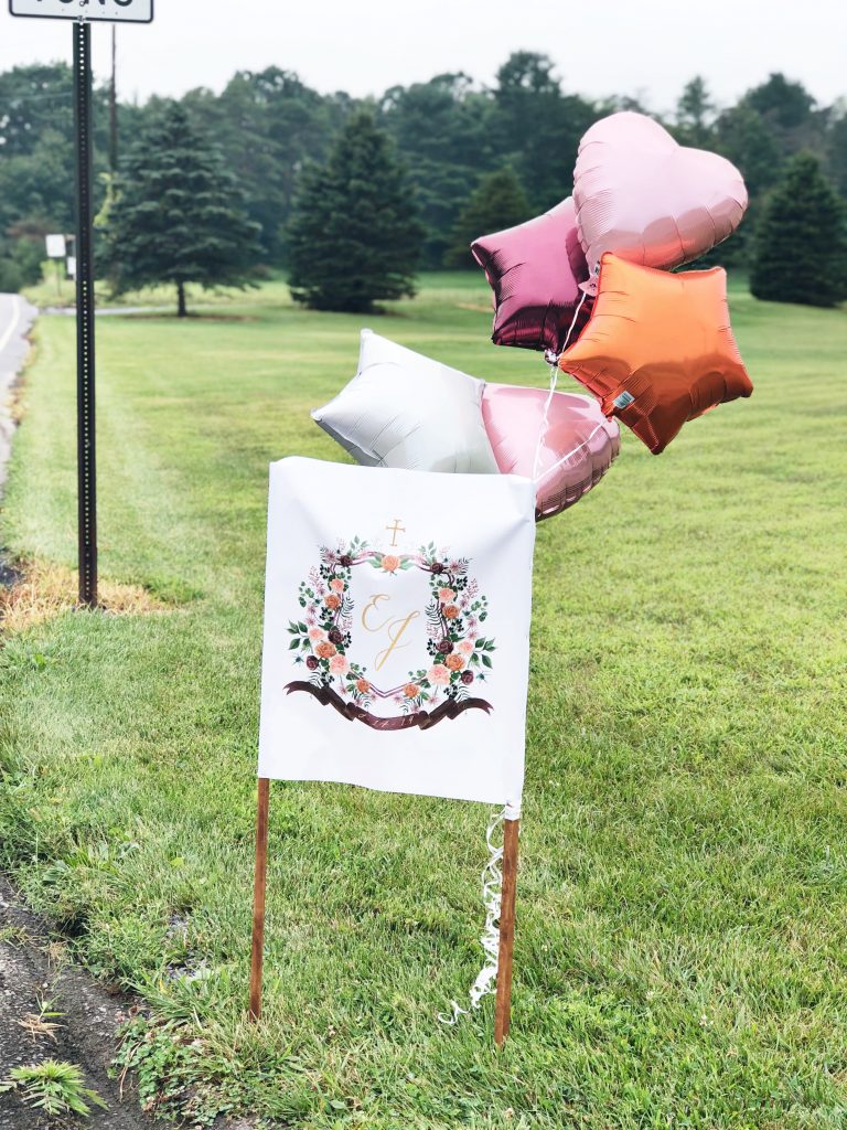 The couple's watercolor wedding crest was used on large signs directing guests to the secluded wedding venue. The crest was painted by Alicia Betz of The Welcoming District.