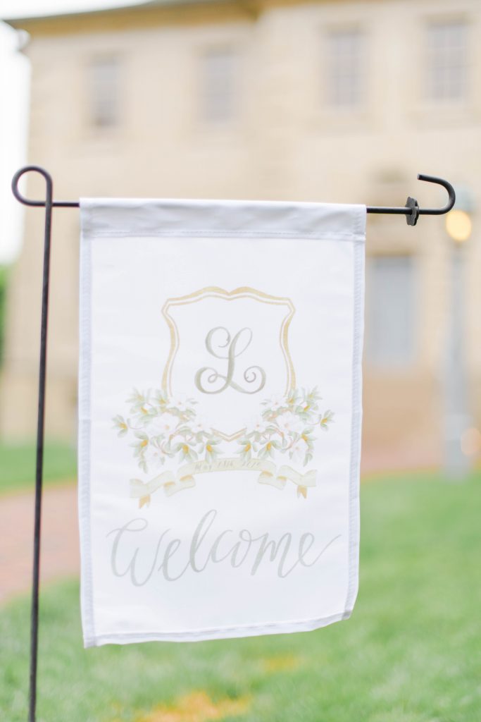 A garden flag featuring a watercolor crest painted by Alicia Betz of The Welcoming District. For more information on ways to get started visit thewelcomingdistrict.com or email alicia@thewelcomingdistrict.com.