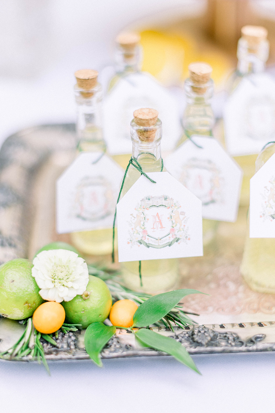 Wedding favor limoncello bottles adorned with a custom wedding crest by The Welcoming District.
