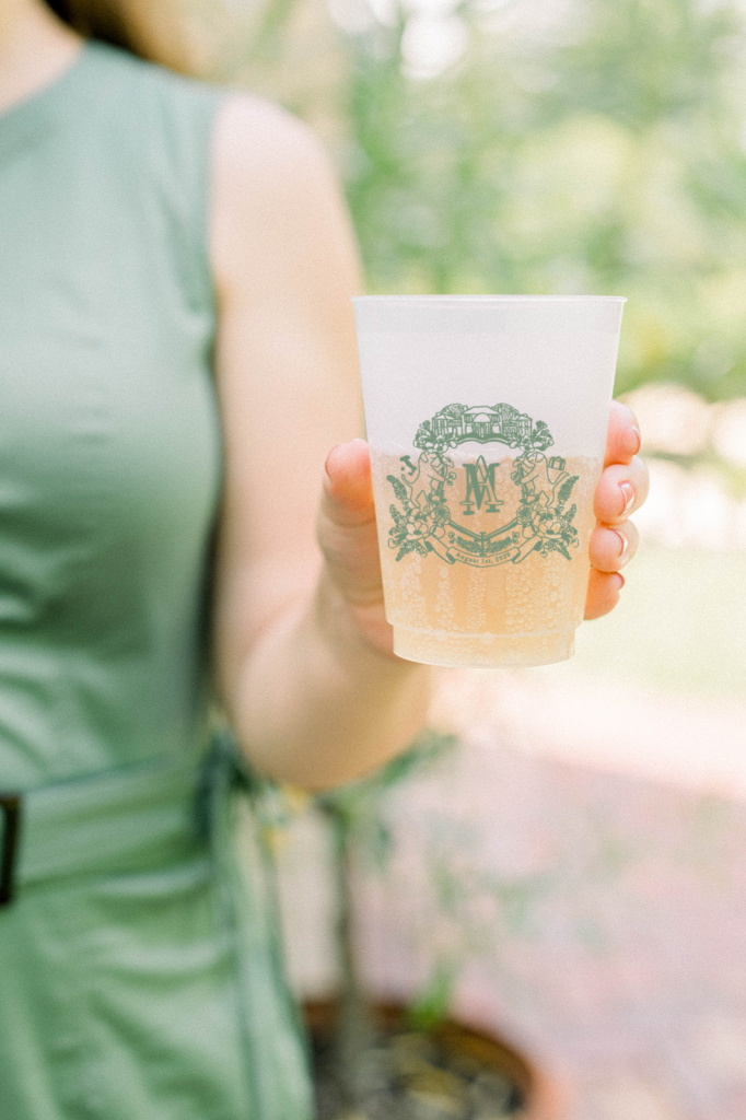 Watercolor wedding crest cups and koozies by The Welcoming District. Visit thewelcomingdistrict.com to get started!